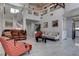 Elegant living space featuring tile floors, high ceilings, and a cozy seating area at 9680 Granite Gorge Ct, Las Vegas, NV 89148