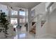 Bright living room featuring tile floors, soaring ceilings, and large windows overlooking the backyard at 9680 Granite Gorge Ct, Las Vegas, NV 89148