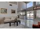 Open-concept living space with tile floors, fireplace, and sliding glass doors leading to the pool area at 9680 Granite Gorge Ct, Las Vegas, NV 89148