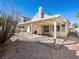 A covered patio enhances this property's backyard, complimented by a desert-landscaped yard at 9725 Sierra Mesa Ave, Las Vegas, NV 89117