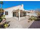Backyard with covered patio featuring desert landscaping, perfect for outdoor entertaining at 9725 Sierra Mesa Ave, Las Vegas, NV 89117