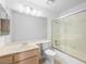 Bright bathroom featuring a single sink, toilet, large mirror and tiled shower over tub at 9725 Sierra Mesa Ave, Las Vegas, NV 89117