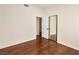 Bedroom featuring dark wood floors, neutral walls, and mirrored closet at 9725 Sierra Mesa Ave, Las Vegas, NV 89117