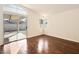 Bright bedroom with wood floors, natural light from windows, and a sliding glass door to patio at 9725 Sierra Mesa Ave, Las Vegas, NV 89117