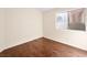 Bedroom features wood floors, a window that allows for natural light, and neutral paint at 9725 Sierra Mesa Ave, Las Vegas, NV 89117