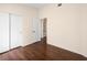 Bedroom featuring wood floors, a sliding door closet and neutral paint throughout at 9725 Sierra Mesa Ave, Las Vegas, NV 89117