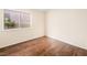 Bedroom with dark floors, window providing natural light, and neutral walls at 9725 Sierra Mesa Ave, Las Vegas, NV 89117