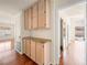 Hallway with wood floors, built in cabinets, counter, and view to outside patio at 9725 Sierra Mesa Ave, Las Vegas, NV 89117