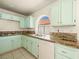 Kitchen featuring granite countertops, stainless steel sink, and green cabinets at 9725 Sierra Mesa Ave, Las Vegas, NV 89117
