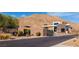 Elegant community entrance showcasing modern architecture and desert landscaping against a mountain backdrop at 9858 Gemstone Sunset Ave, Las Vegas, NV 89148