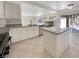 Bright kitchen with an island, stainless steel appliances, granite counters, and backyard access at 9885 Ramhorn Canyon St, Las Vegas, NV 89183