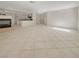 Open-concept living area with tile flooring, a fireplace, and seamless connection to the kitchen at 9885 Ramhorn Canyon St, Las Vegas, NV 89183