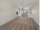 Bright living room with decorative pillars creating an open-concept feel and neutral carpeting at 9885 Ramhorn Canyon St, Las Vegas, NV 89183