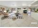Staged living room featuring a fireplace, tile flooring, and sliding glass doors at 9885 Ramhorn Canyon St, Las Vegas, NV 89183