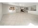Open living space with tile flooring, a fireplace, and an open layout to the kitchen area at 9885 Ramhorn Canyon St, Las Vegas, NV 89183