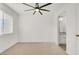 Bedroom with carpeted floors, a ceiling fan, a window and an ensuite bathroom at 9920 Keephills St, Las Vegas, NV 89183