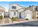 Two-story home with a one-car garage, neutral toned exterior, and a low maintenance front yard at 9920 Keephills St, Las Vegas, NV 89183