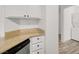 Kitchen counter and lower cabinets with view of the laundry and a partial view of the bathroom at 9920 Keephills St, Las Vegas, NV 89183