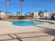 Community pool with clear blue water surrounded by palm trees at 9920 Keephills St, Las Vegas, NV 89183