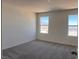 Bedroom with gray carpet and two windows at 10012 River Corral St, Las Vegas, NV 89166