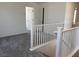 Upstairs hallway with gray carpet and white painted doors at 10012 River Corral St, Las Vegas, NV 89166