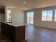 Open-concept kitchen features a center island, stainless steel appliances, sliding glass doors and mountain views at 10012 River Corral St, Las Vegas, NV 89166
