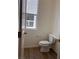 A half bathroom with wood look floors and a window at 10012 River Corral St, Las Vegas, NV 89166