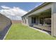 Private backyard featuring artificial turf, a built-in patio, and an enclosed fence for added privacy at 10065 Auburn Rose Ave, Las Vegas, NV 89143