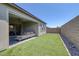 Private backyard featuring artificial turf, an enclosed fence, and a covered patio with outdoor seating at 10065 Auburn Rose Ave, Las Vegas, NV 89143