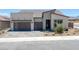 Contemporary home with a three-car garage and low-maintenance front yard at 10065 Auburn Rose Ave, Las Vegas, NV 89143