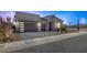 Modern home featuring a three-car garage and neatly landscaped front yard at 10065 Auburn Rose Ave, Las Vegas, NV 89143