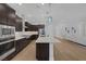 Bright, open kitchen with granite countertops, stainless appliances, pendant lighting, and access to the living room at 10065 Auburn Rose Ave, Las Vegas, NV 89143