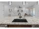 Modern kitchen with granite countertops, stainless steel appliances, and dark cabinetry at 10065 Auburn Rose Ave, Las Vegas, NV 89143