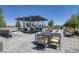 Stylish outdoor seating area boasts comfortable furnishings, modern pergolas, and a game area at 10065 Auburn Rose Ave, Las Vegas, NV 89143