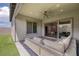 Relaxing outdoor patio with comfortable seating, ceiling fan, and an enclosed private yard at 10065 Auburn Rose Ave, Las Vegas, NV 89143