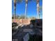 Backyard featuring desert landscaping, rock features, block fence, and palm trees at 10134 Reflection Brook Ave, Las Vegas, NV 89148