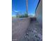 Backyard featuring block wall, desert landscaping with rock ground cover, plants, and gravel at 10134 Reflection Brook Ave, Las Vegas, NV 89148