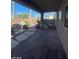 Backyard featuring brick patio, desert landscaping, rock features, and covered patio at 10134 Reflection Brook Ave, Las Vegas, NV 89148