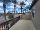 Balcony view of neighborhood streets with mature palm trees; black metal railing in foreground at 10134 Reflection Brook Ave, Las Vegas, NV 89148