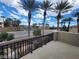 Balcony view shows neighborhood streets, mature palm trees, and iron railing in foreground at 10134 Reflection Brook Ave, Las Vegas, NV 89148