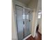 Bathroom with a glass enclosed shower and white tile at 10134 Reflection Brook Ave, Las Vegas, NV 89148