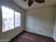Well-lit bedroom with a large window, ceiling fan, and neutral walls providing a comfortable space at 10134 Reflection Brook Ave, Las Vegas, NV 89148