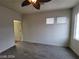 Bright bedroom with a modern ceiling fan, new flooring, and natural light from large windows at 10134 Reflection Brook Ave, Las Vegas, NV 89148