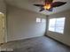 This bedroom boasts natural light from two windows and a unique leaf-shaped ceiling fan at 10134 Reflection Brook Ave, Las Vegas, NV 89148