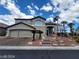 Charming two-story home featuring a stucco exterior, a two-car garage, and landscaped front yard with palm trees at 10134 Reflection Brook Ave, Las Vegas, NV 89148