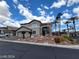 Charming two-story home featuring a stucco exterior, a two-car garage, and landscaped front yard with palm trees at 10134 Reflection Brook Ave, Las Vegas, NV 89148