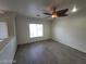 Bright living room featuring wood-look flooring, ceiling fan and natural light at 10134 Reflection Brook Ave, Las Vegas, NV 89148