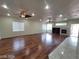 Spacious living room featuring hardwood floors, ceiling fans, a fireplace, and recessed lights at 10134 Reflection Brook Ave, Las Vegas, NV 89148