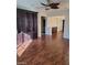 Spacious living room featuring hardwood floors, ceiling fan and built-in shelves at 10134 Reflection Brook Ave, Las Vegas, NV 89148