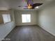 Bright living room featuring wood-look flooring, ceiling fan and natural light at 10134 Reflection Brook Ave, Las Vegas, NV 89148